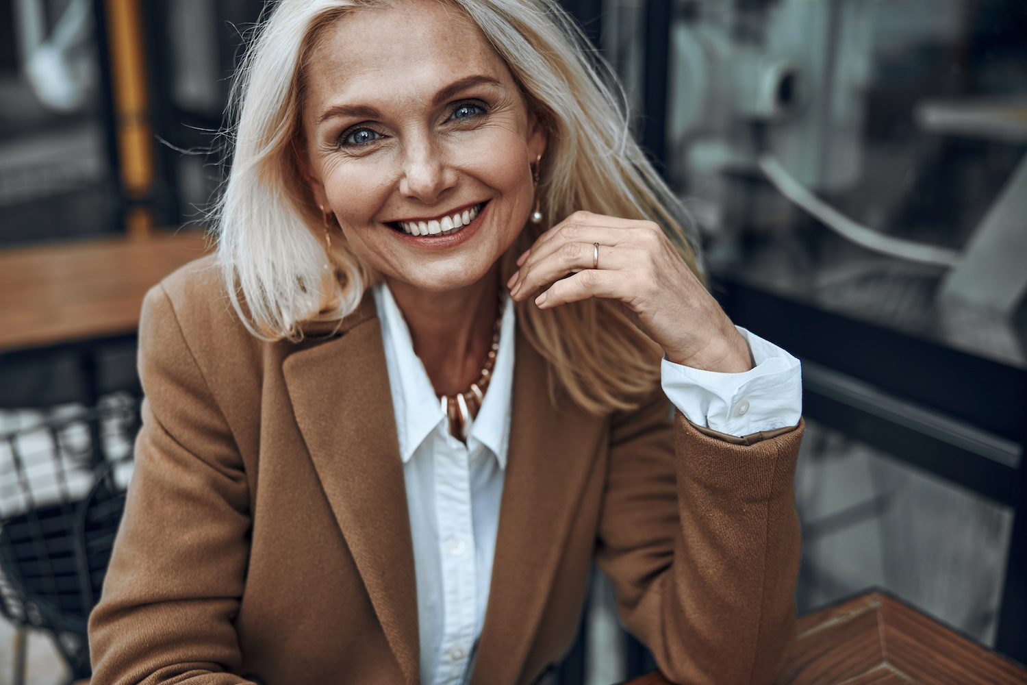 beautiful mature woman smiling at a cafe