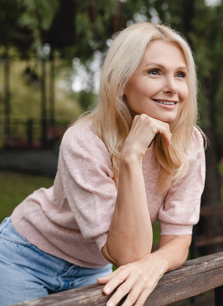 beautiful mature woman standing in a park