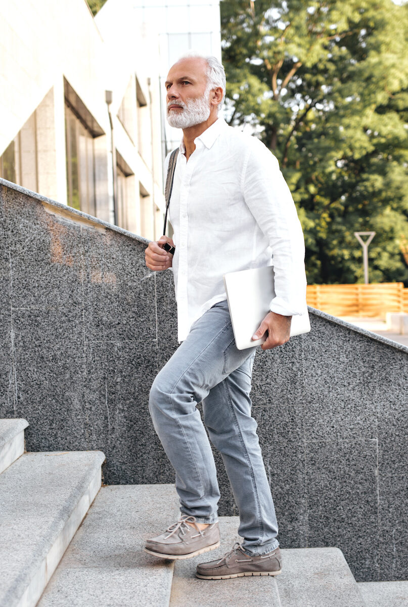 mature man walking up city steps